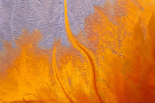 Abstract flowing rivers on vibrant orange, blue, red colors. Top view