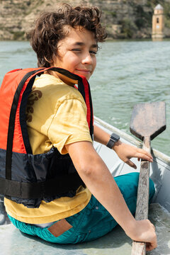 young boy sitting boat