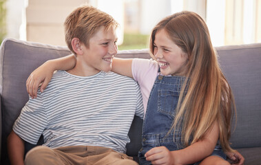 Love, family and sister with brother on a sofa, laughing and relax while having fun in their home together. Happy, siblings and girl with boy on a couch, enjoy bonding moment in living room in Russia