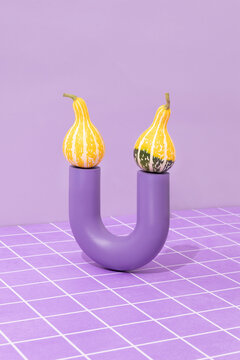 Yellow ornamental gourds with 3d objects and purple tiles.
