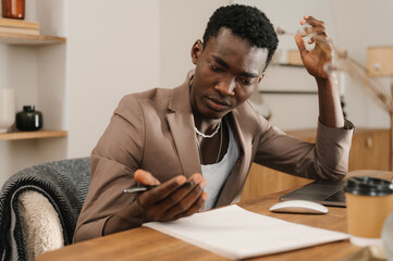 Puzzled  man doing paperwork