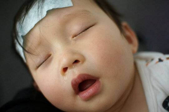 Close up sleeping asian kid, have a fever