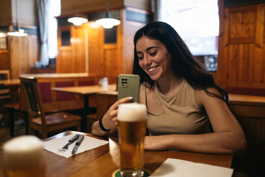 Woman taking smartphone photos in a restaurant