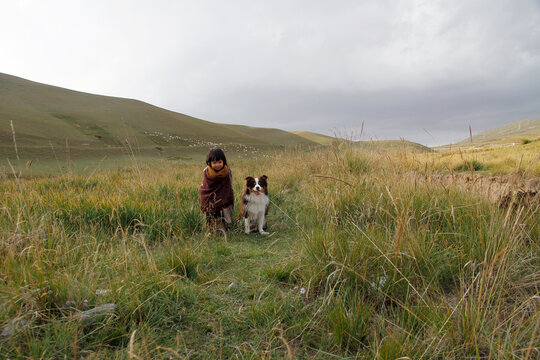Asian little girl playing in the prairie of northwest China