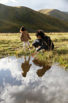 Asian mother and daughter play in the prairie of northwest China
