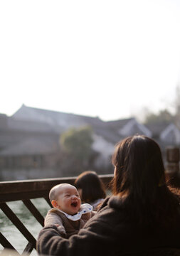 Asian mother and son daughter riverside in ancient Chinese town