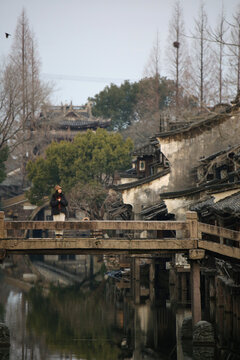 Asian woman on the bridge in Chinese style ancient town

