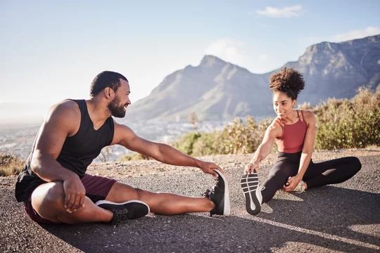 Premium Photo  Girl athlete does warmup on legs before physical exertion  workout on the street site