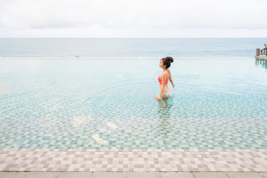 Beautiful woman relaxed and enjoyed nature in infinity pool