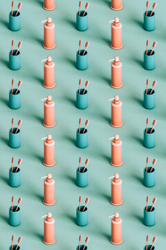 many pink toothbrushes and soap