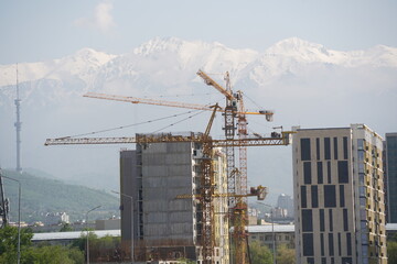 Almaty, Kazakhstan - 04.26.2022 : Construction of a high-rise residential complex near a road junction.