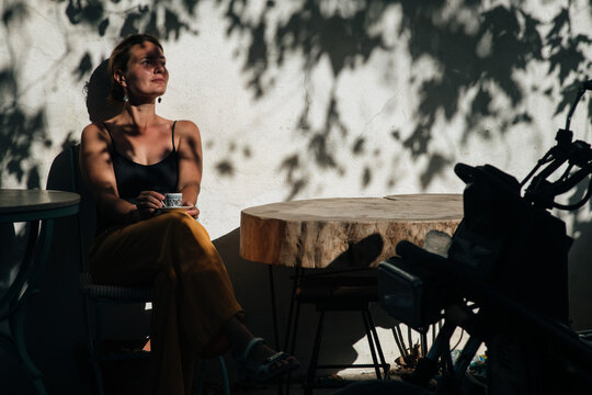 Istanbul vibe, woman drinking coffee in the street cafe, Turkey