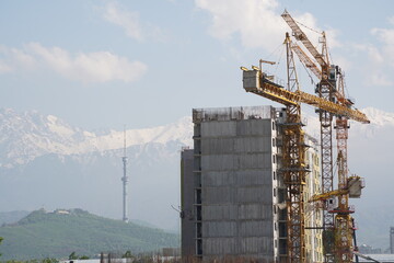 Almaty, Kazakhstan - 04.26.2022 : Construction of a high-rise residential complex near a road...