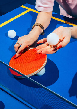 Female playing ping pong.