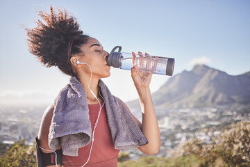 Music, workout and woman drinking water after exercise at sunrise along mountain, wellness and...