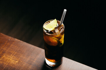 Cuba libre cocktail cold and refreshing drink for summer days on black background
