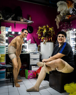 Drag queens put their leggings on backstage at a performance