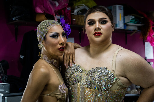 Drag queens pose for a portrait together backstage after getting ready