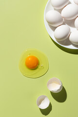 Easter decoration white eggs on yellow background. Top view