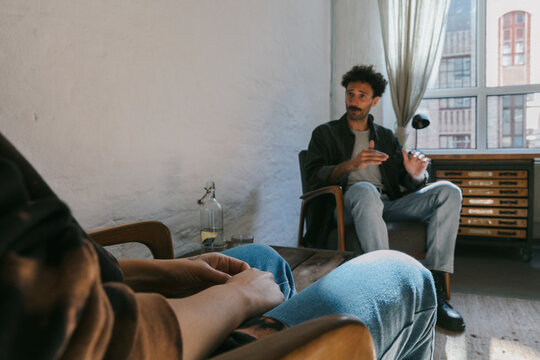 Male Therapist Talking to Anonymous Client