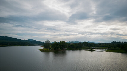 Natural lanscape of green trees in meadow near moutain with skyline reflection on the pond
