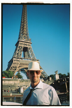 Man portrait in Paris wearing smart outfit with tie and sunglasses 
