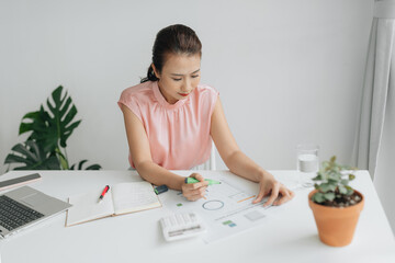 Hands of businesswoman highlighting important data in financial report