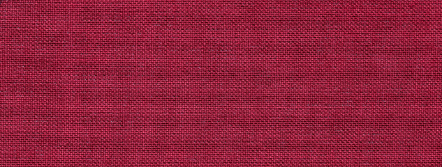 Texture of dark red color background from textile material with wicker pattern. Vintage wine fabric