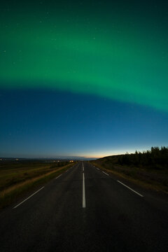 Aurora Borealis, Northern Lights Over empty road In Iceland
