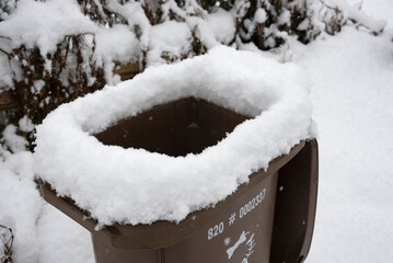 Recycle bin covered with snow