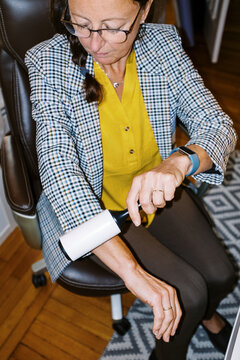 lo-fi flash image of middle-aged woman cleaning lint off her blazer