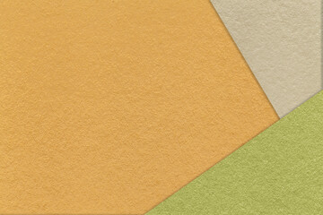Texture of craft orange color paper background with beige and green border. Vintage abstract yellow cardboard.