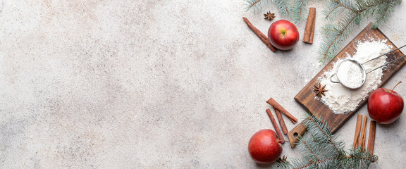 Wooden board with flour, apples and spices for Christmas cake on grunge background with space for...