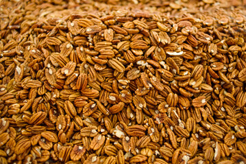 Group of shelled walnuts cut in half. Background, texture of nut halves.