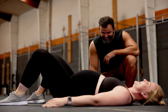 Pregnant woman working with a gym trainer