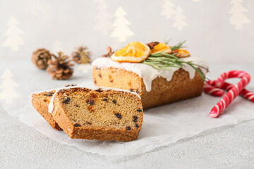 Tasty Christmas stollen on grey background