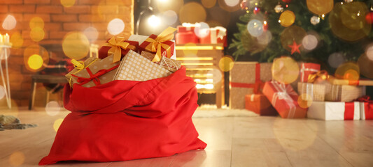 Santa bag with gifts on floor in living room