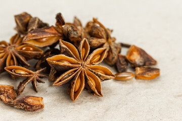 heap star anise front view on brown paper background.