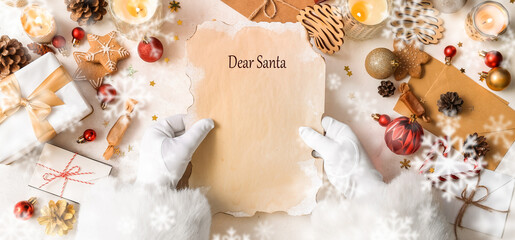 Santa Claus with blank letter at white table, top view
