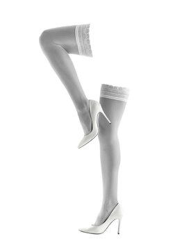 Legs of beautiful woman in stockings and high-heeled shoes isolated on white