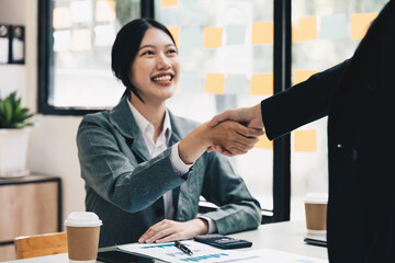 Welcome to our team. close up young modern women shaking hands while working in the creative office