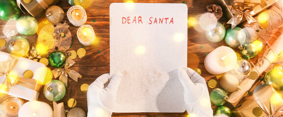 Santa Claus with blank letter at wooden table, top view