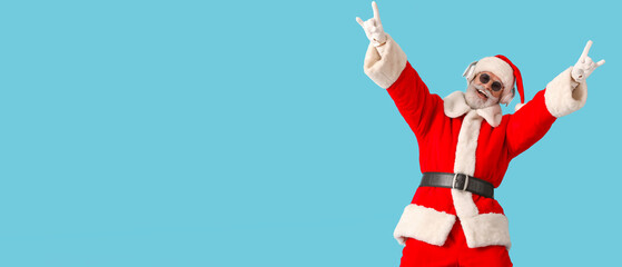 Cool Santa Claus listening to music on light blue background with space for text