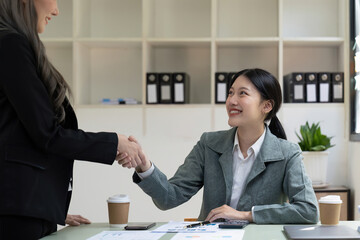Welcome to our team. close up young modern women shaking hands while working in the creative office