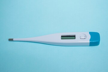 Digital thermometer isolated on blue background with copyspace - the concept of health