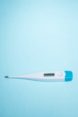 Digital thermometer isolated on blue background with copyspace - the concept of health
