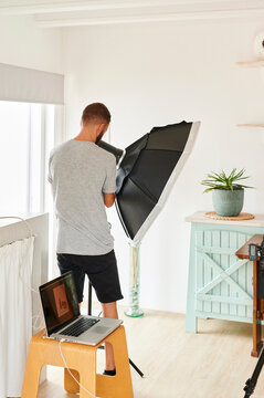 Photographer adjusting a light for a shoot