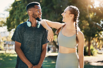 Fitness, couple and talking in nature after running, workout or exercise. Diversity, happy man and woman in discussion on break after training or exercising for wellness, health or healthcare at park