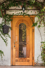 Building with ornate door and climbing plant