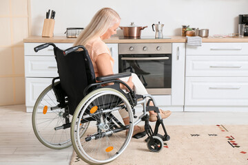 Mature woman with physical disability in kitchen